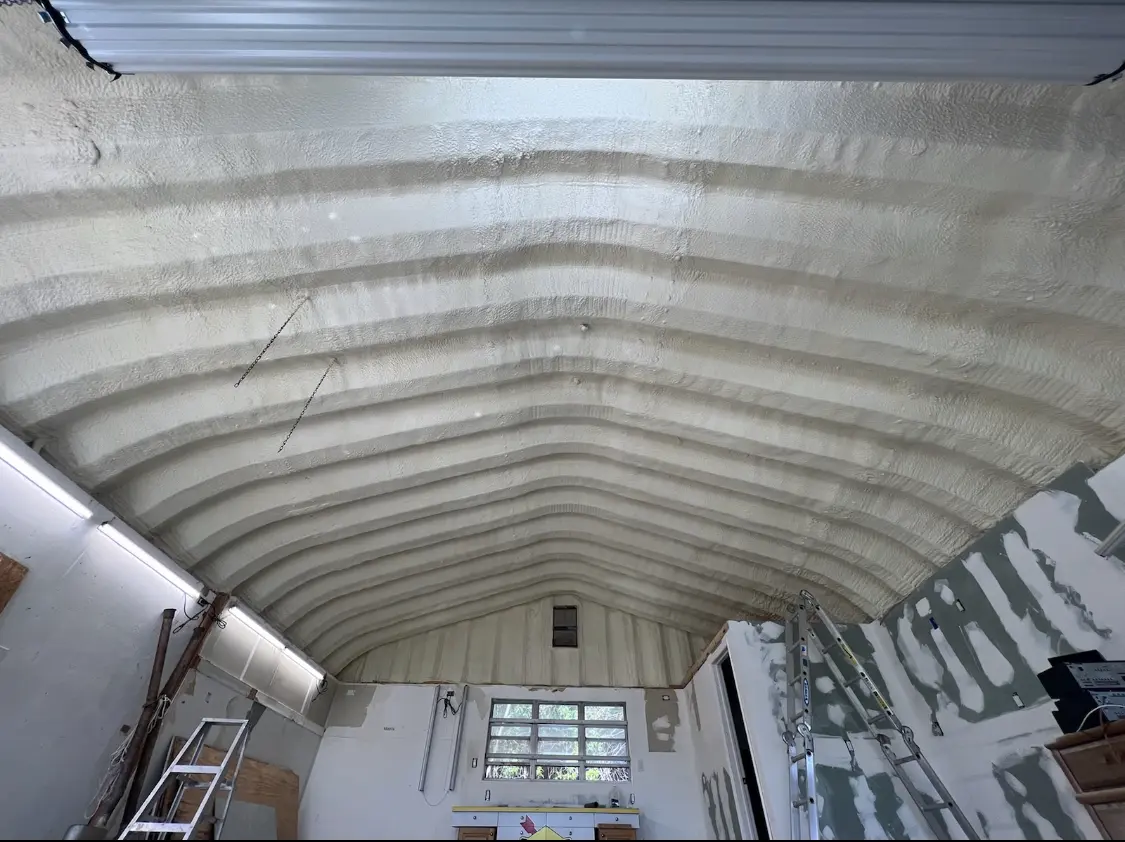 Spray polyurethane foam applied to the underside of a metal roof deck in Selma